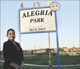  ?? PHOTO BY CESAR NEYOY/BAJO EL SOL ?? SAN LUIS RESIDENT MARIA ALEGRIA, next to a newly unveiled sign that honors her efforts to create a park in the city.