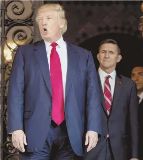  ?? AP FILE PHOTO ?? ROGUE ELEMENT? President Trump walks with former Gen. Michael Flynn, who is seeking immunity to tell his ‘story’ regarding Russia.
