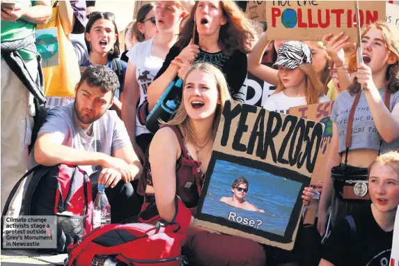  ??  ?? Climate change activists stage a protest outside Grey’s Monument in Newcastle