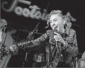  ?? Laura Roberts / Invision / AP ?? Miley Cyrus performs at a private concert event at Tootsie’s to celebrate the release of her album “Younger Now” in Nashville, Tenn.