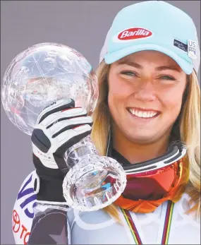  ?? Gabriele Facciotti / Associated Press ?? Mikaela Shiffrin holds the women’s World Cup slalom discipline trophy, at the alpine ski World Cup finals in Soldeu, Andorra on Saturday.