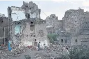  ??  ?? GROWING OUTCRY: Boys play in the rubble of a home destroyed by an air strike in the Old City of Sana’a, Yemen.