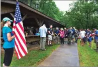  ??  ?? Lt. Col. Herbert Hodde, 188th Wing chaplain, leads airmen and their families in a prayer at the start of the 50 Summit Challenge on May 8 at Mount Magazine State Park. The challenge was designed for airmen to proudly display the Air Force flag from the...