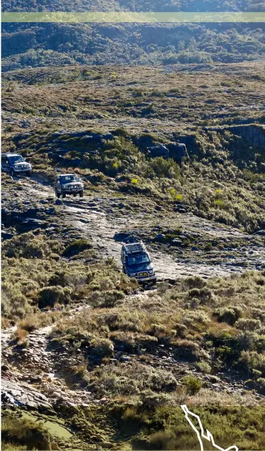  ??  ?? Convoy of 4WDs making their way across the low scrub and slabs of the Denniston Plateau.