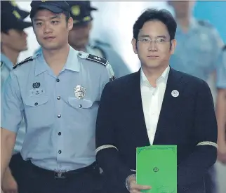  ?? AHN YOUNG-JOON/AFP/GETTY IMAGES ?? Lee Jae-yong, centre, vice-chairman of Samsung Electronic­s and heir to the business empire, arrives for his trial in Seoul on Monday. Lee, who has denied all bribery-related charges, may be the first in his family to serve a prison term if convicted.