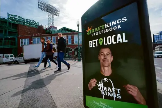  ?? CHARLES KRUPA/ASSOCIATED PRESS ?? A DraftKings sign outside Fenway Park featured former Bruin Zdeno Chara, one of the local sports stars in an ad campaign.