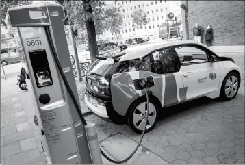  ?? DANIEL BOCKWOLDT/DPA VIA AP ?? IN THIS OCT. 18 FILE PHOTO, A CAR IS CONNECTED to a charging station for electric vehicles in Hamburg, Germany. Representa­tives from the Tucson Electric Vehicle Associatio­n will discuss the organizati­on’s goal of increasing the public’s awareness and...