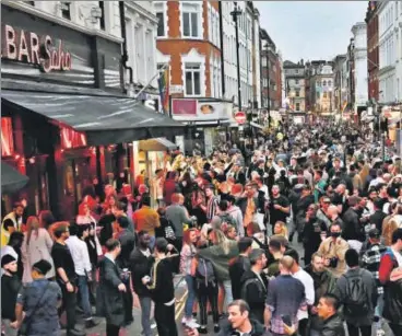  ?? AFP ?? LET LOOSE: Revellers pack a street outside bars in the Soho area of London as Covid-19 restrictio­ns were further eased on Saturday.