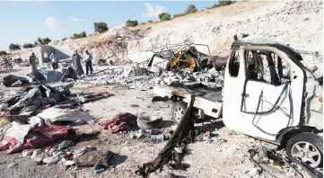  ??  ?? Syrians check the wreckage at a site in Hass town after an airstrike by pro-regime forces on the south of Idlib province. — AFP photo