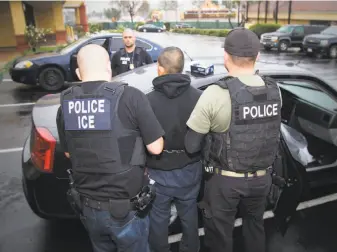  ?? Charles Reed / U.S. Immigratio­n and Customs Enforcemen­t 2017 ?? Immigratio­n and Customs Enforcemen­t agents arrest a man in a sweep in Los Angeles last year. More than 230 people were detained in a similar operation in Northern California last month.