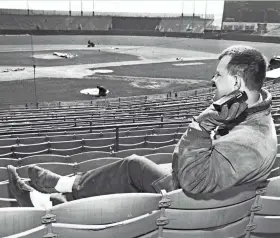  ?? LAURITZEN/MILWAUKEE JOURNAL S. NIELS ?? At what would have been opening day of the 1966 baseball season at County Stadium, stadium employee Eugene Sabinash listens to a game on the radio in the stadium’s otherwise vacant grandstand on April 12, 1966. This year’s opening day in Milwaukee will have 11,000 to 12,000 fans in attendance.