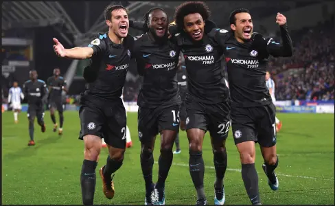  ??  ?? Willian (second from right) and Co celebrate as Chelsea romped to a 3-1 win over Huddersfie­ld Town to keep themselves relevant in the title race