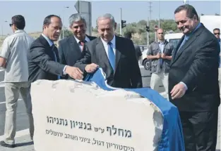  ?? (Kobi Gideon/GPO) ?? PRIME MINISTER Binyamin Netanyahu (center) inaugurate­s an interchang­e in east Jerusalem named for his father, Benzion, yesterday, as Mayor Nir Barkat (far left) and Transporta­tion Minister Israel Katz (right) look on.