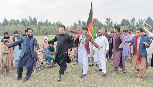  ??  ?? OVERCOME WITH JOY: Youth dance as they celebrate a reduction in violence, in Jalalabad on Friday.