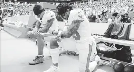  ?? WILFREDO LEE THE ASSOCIATED PRESS ?? Dolphins Kenny Stills, left, and Albert Wilson kneel during the playing of the U.S. national anthem before a game against the Tennessee Titans on Sunday in Miami Gardens, Fla.
