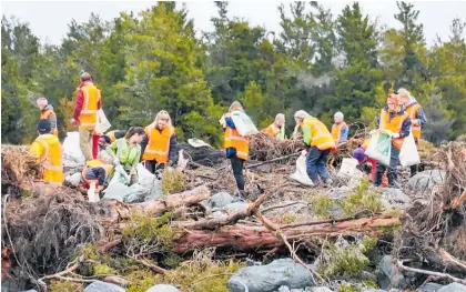  ??  ?? Hundreds worked on the huge cleanup after a landfill near Fox Glacier was washed away last year.