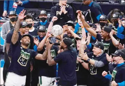  ??  ?? The Milwaukee Bucks celebrate with the conference trophy after defeating the Atlanta Hawks in Game 6 of the Eastern Conference finals in the NBA basketball playoffs in Atlanta. (AP)