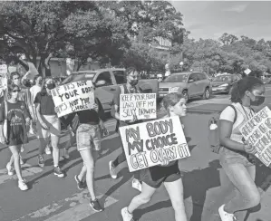  ?? JAY JANNER/AUSTIN AMERICAN-STATESMAN ?? University of Texas students march from campus to the Capitol in Austin on Tuesday to protest the new abortion law.