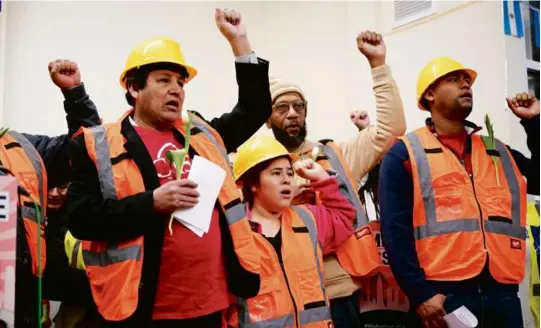  ?? MANDEL NGAN/AFP VIA GETTY IMAGES ?? Baltimore workers and labor officials held a press conference Friday to honor families and victims of Tuesday’s collapse of the Francis Scott Key Bridge. A crane worked to clear some of the debris.