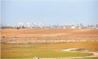  ?? PHOTOS BY PAUL H. WILLIAMS ?? A long shot of the Palestinia­n’s Gaza Strip from near the border with Israel. Missiles are likely to land at the this spot.