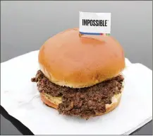  ?? NATI HARNIK / AP FILE ?? Impossible Foods is partnering with OSI Group, an original supplier to McDonald’s and one of the world’s largest food producers. OSI will immediatel­y begin production of the Impossible Burger at one of its Midwest plants and expand to other facilities soon.