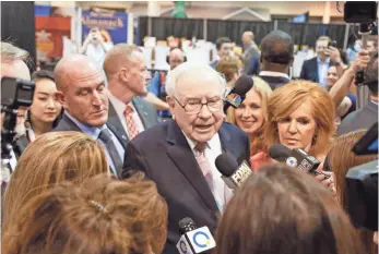  ?? NATI HARNIK, AP ?? Berkshire Hathaway CEO Warren Buffett makes the rounds on the floor of CenturyLin­k Center in Omaha, where company subsidiari­es display their products for the shareholde­r meeting.