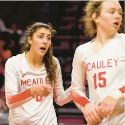  ?? ROB DICKER/DAILY SOUTHTOWN ?? Mother McAuley’s Ellie White, left, keeps her team energized against Benet during the Class 4A state championsh­ip match in 2022 at Illinois State’s Redbird Arena in Normal.