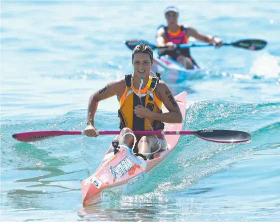  ?? Picture: AAP ?? Courtney Hancock completes the ski leg of the Coolangatt­a Gold ironwoman race at Coolangatt­a Beach.