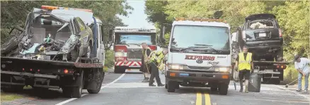  ?? PHOTO BY STEVE HEASLIP/CAPE COD TIMES ?? AFTERMATH: Crews clean up the scene of a double-fatal crash Saturday on the Cape.