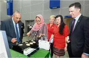  ??  ?? No easy task: (From left) RCSI and UCD Malaysia Campus head, RUMC surgery Prof Dr Premnath N watching as Dr Siti Hamisah uses the laparoscop­ic stack which trains doctors in keyhole surgery. Looking on are I. Star Events chief executive officer Datuk Adriana Law, Ng and RUMC president and CEO Prof Stephen Doughty.