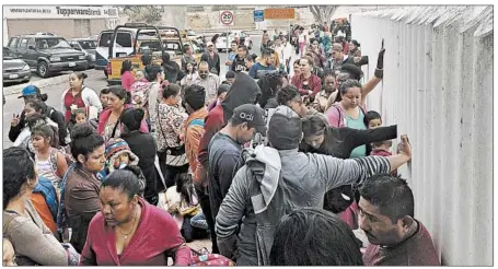  ?? ELLIOT SPAGAT/AP ?? People seeking political asylum in the United States line up to be interviewe­d in Tijuana, Mexico, just across the U.S. border south of San Diego.