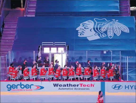  ?? CHRIS SWEDA/CHICAGO TRIBUNE ?? Playing in an empty United Center because of the coronaviru­s pandemic, the Blackhawks stand for the national anthem before a game against the Blue Jackets on Jan. 29 at the United Center.