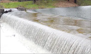  ?? Westside Eagle Observer/MIKE ECKELS ?? With 6-10 inches of rain falling within a 12-hour period March 19, lake levels were higher than the top of the spillway at Crystal Lake near Decatur, forcing a dangerous flow of water into Wolf Creek.