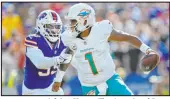  ?? Adrian Kraus The Associated Press ?? Bills defensive end Kingsley Jonathan tracks down Dolphins quarterbac­k Tua Tagovailoa. Buffalo sacked him four times Sunday.
