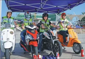  ?? PHOTOS PROVIDED TO CHINA DAILY ?? Members of the Qingdao Voluntary Road Rescue Team appear at an event to mark the launch of its motorbike division in Qingdao, Shandong province.