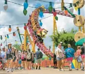  ?? JOE BURBANK/ORLANDO SENTINEL ?? Hollywood Studios guests walk near Slinky Dog Dash at Toy Story Land in 2023.