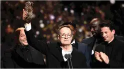  ??  ?? French producer Jean Labadie stands on stage after “Les Miserables” received the Audience’s Cesar award.