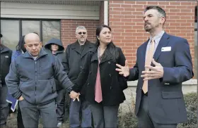  ?? File Photo/NWA Democrat-Gazette/JASON IVESTER ?? Jose and Amanda Aristondo hold hands and listen as Pastor Mark Snodgrass (right) speaks March 14 outside the U.S. Immigratio­n and Customs Enforcemen­t office in Fayettevil­le.