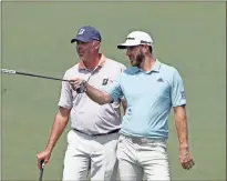  ?? Ap-curtis Compton ?? Dustin Johnson, right, and Matt Kuchar look over a shot on the second hole during a practice round for the Masters golf tournament at Augusta National Golf Club in Augusta on Wednesday.