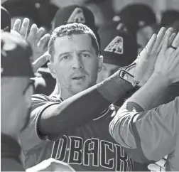  ??  ?? Diamondbac­ks shortstop Nick Ahmed celebrates after scoring against the Dodgers in the second inning on Tuesday.