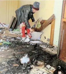  ?? Picture: FREDLIN ADRIAAN ?? CHARRED MESS: Greenville Primary School governing body chair Ashley Le Bron cleans up a storage room that was set alight yesterday