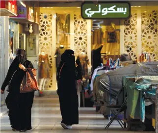  ??  ?? Shoppers at a Riyadh market. Business conditions are improving in Saudi Arabia, according to the latest PMI survey. (Reuters)