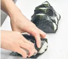  ?? ?? A staff member making rice balls, known as ‘onigiri’, at the restaurant Onigiri Bongo in the Otsuka area of Tokyo.