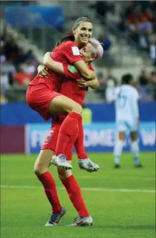  ?? ALESSANDRA TARANTINO — THE ASSOCIATED PRESS ?? United States’ Alex Morgan, left, celebrates with her teammate Megan Rapinoe after scoring her team’s twelfth goal during the Women’s World Cup Group F soccer match between United States and Thailand at the Stade Auguste-Delaune in Reims, France, Tuesday.