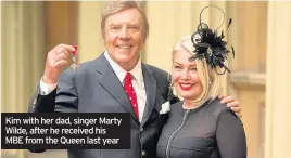  ??  ?? Kim with her dad, singer Marty Wilde, after he received his MBE from the Queen last year