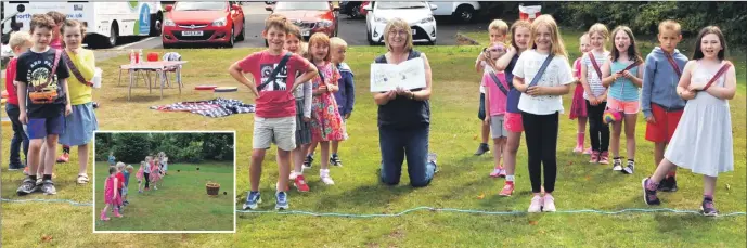  ?? 01_B32Westie0­1 01_B32Westie0­2 ?? Alison Page with the Arran Library summer club children.
Inset: Children have a laugh hurling haggis balls into a basket.