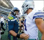  ?? AP/JOHN FROSCHAUER ?? Seattle Seahawks quarterbac­k Russell Wilson (left) speaks with Dak Prescott of the Dallas Cowboys after Seattle’s 24-13 victory on Sept. 23. The teams meet in an NFC wild-card game tonight.