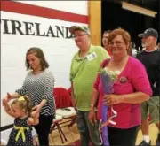  ?? CAROL HARPER — THE MORNING JOURNAL ?? Patty Hunter, in pink, mother of Army SSG James P. Hunter, smiled through tears as she left Firelands High School gymnasium Oct. 3 after a new retractabl­e flag was unfurled in a ceremony honoring her son and other veterans. A Firelands alumni, James...