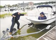  ?? Tyler Sizemore / Hearst Connecticu­t Media ?? Cos Cob resident Tony Rizzi takes his boat out of the water before the anticipate­d rainfall from Hurricane Florence at the Mianus River Boat &amp; Yacht Club in the Cos Cob section of Greenwich on Tuesday. Hurricane Florence is expected to make landfall in the Carolinas by the end of the week, and heavy rain could hit the Greenwich area in associatio­n with the storm.