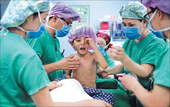  ?? WANG JING / CHINA DAILY ?? A child with congenital heart disease from Afghanista­n is prepared for an operation at the First Affiliated Hospital of Xinjiang Medical University in northweste­rn China on Saturday. The program is part of the Red Cross Society of China’s humanitari­an...